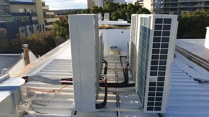 Daikin outdoor units being set up in Sydney during an air conditioning service.