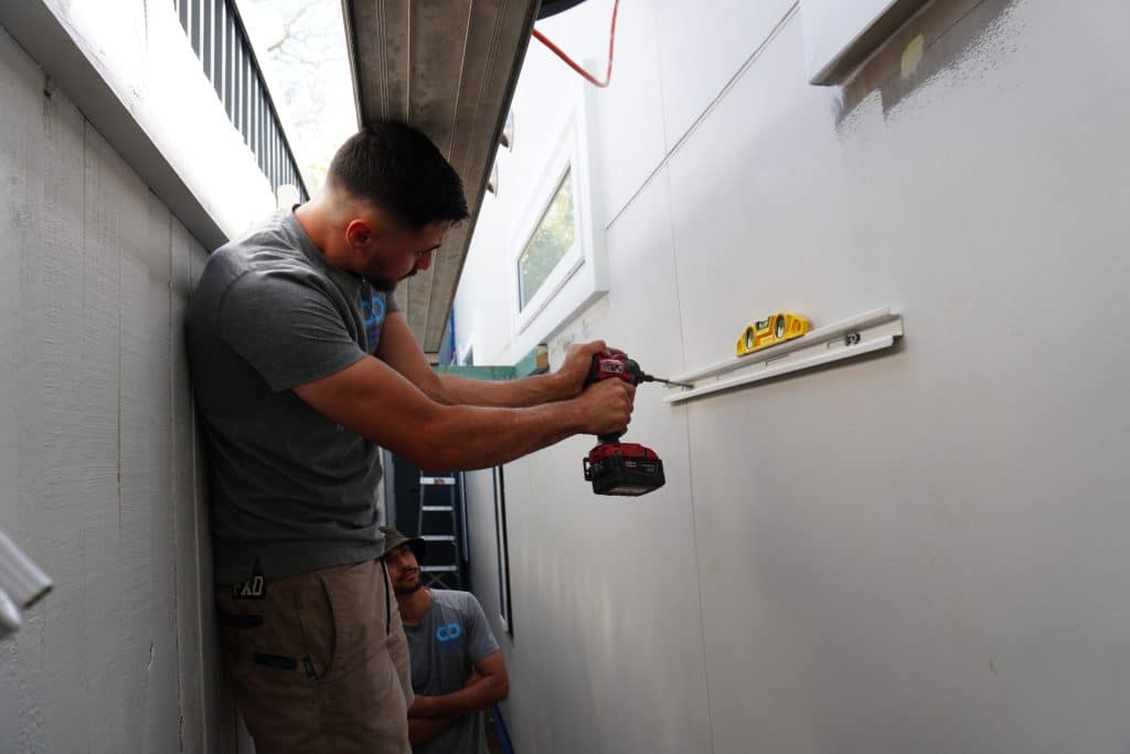 A local aircon technician installing a split system